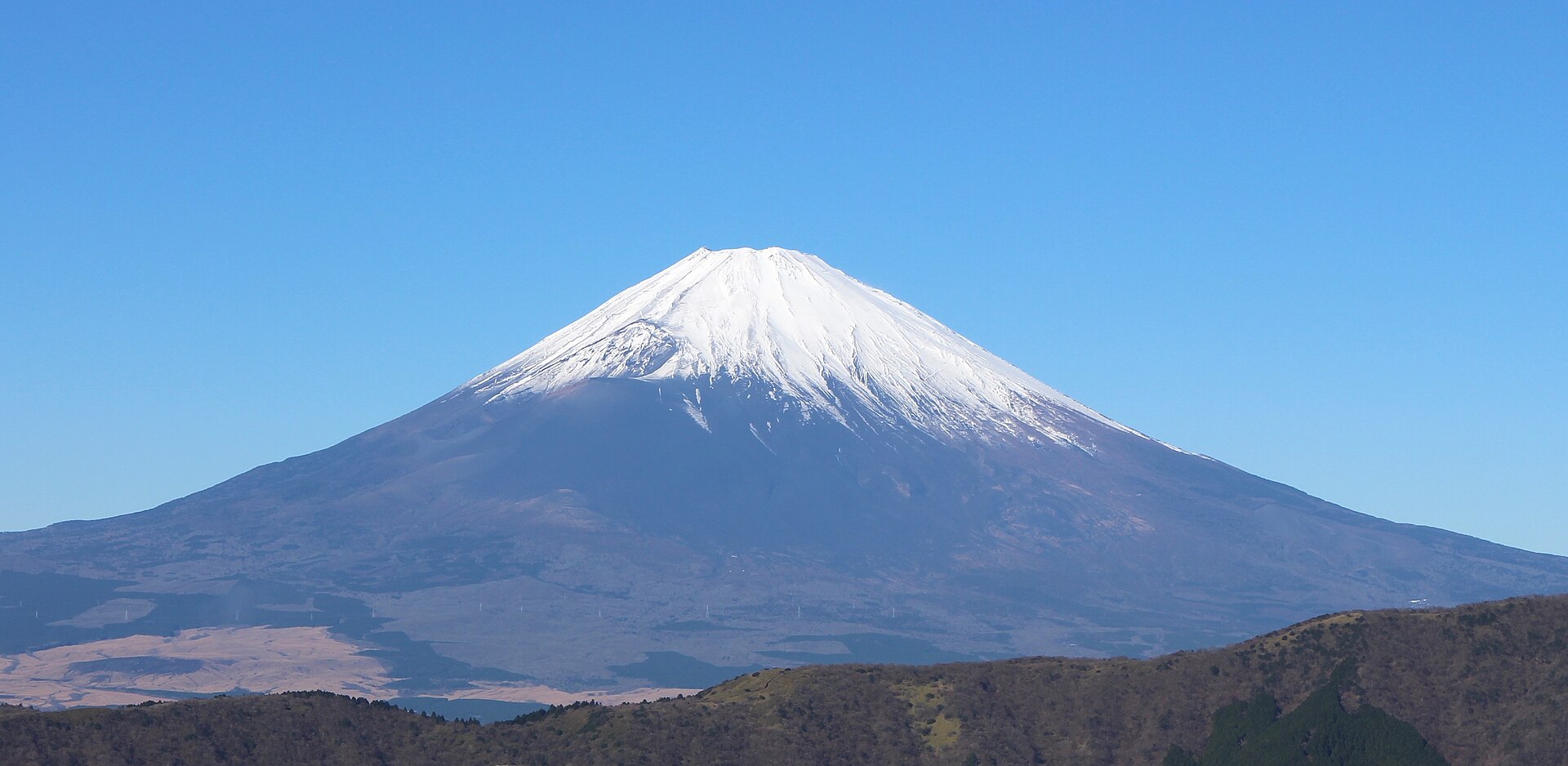 Mount Fuji beyond a calm lake near Hakone